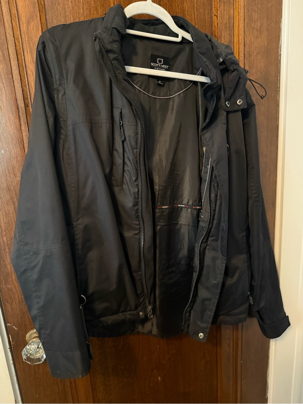SCOTTeVEST Revolution convertible travel jacket in black, men’s size Medium.